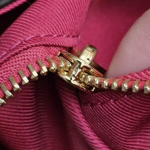 Gold-tone zip pull on the interior pocket