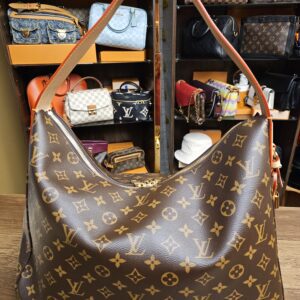 Slouchy MM seen at an angle with the vachetta strap raised