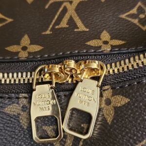 Gold-tone double zip pulls below the LV on the canvas