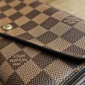 LOUIS VUITTON PARIS marking on the Damier Ebene canvas below the flap