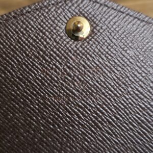 Snap on the brown leather underside of the flap