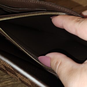 Zip coin compartment held open inside the wallet