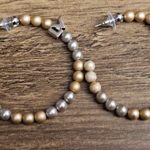 Louis Vuitton Billie Faux Pearl Hoop Earrings Gold Silver - the pair laid flat showing the gold-tone and silver beads