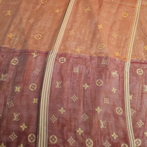 Layered sheer silk showing the Monogram pattern and striped border