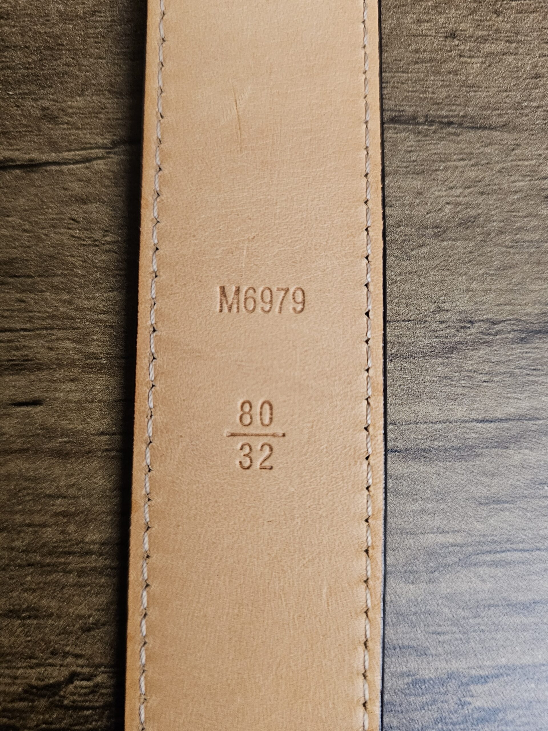 Leather underside stamped M6979 and size 80/32