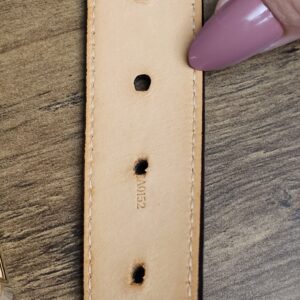 Belt holes showing wear on the leather underside