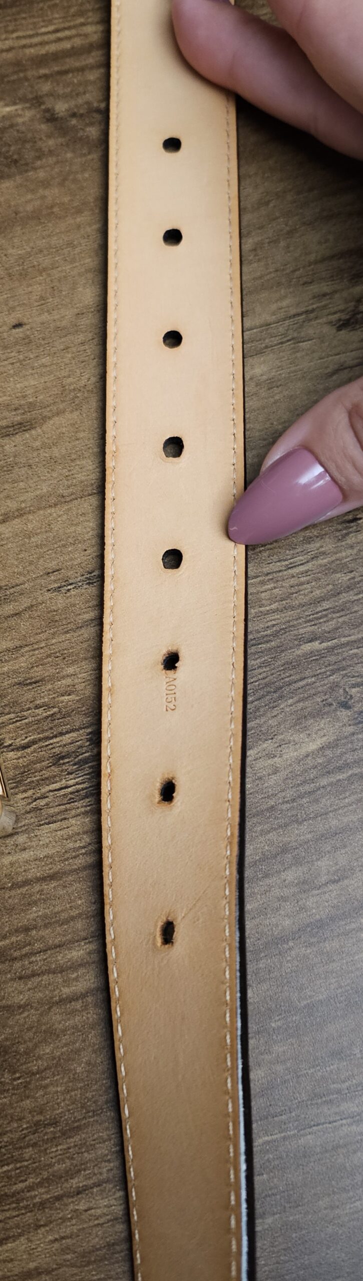Belt holes showing wear on the leather underside