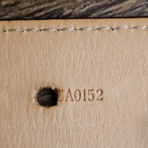 Date code CA0152 stamped beside a belt hole
