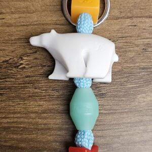 Polar Bear charm laid out showing the LV cube, bear and colored beads
