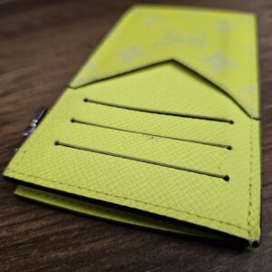 Three card slots on the yellow Taïga leather