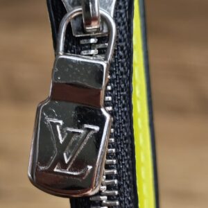 Silver-tone LV zip pull on the yellow card holder