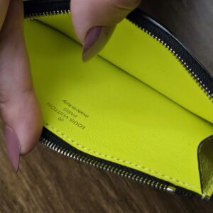 Zipped compartment held open inside the card holder