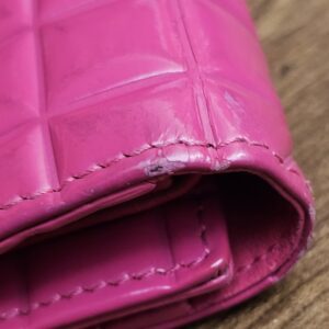 Fold edge of the wallet showing rubbing and finish loss