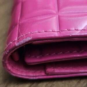 Edge of the wallet showing finish loss along the fold