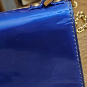 Back corner of the metallic blue patent bag