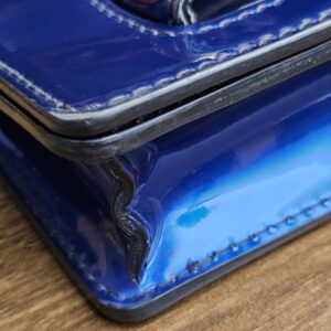Edge of the flap showing rubbing and finish loss