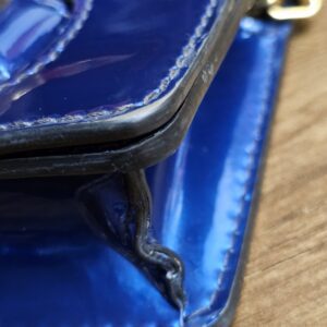Corner of the bag with visible scuffs and color loss