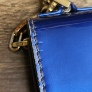 Chain attachment and hardware on the side of the bag