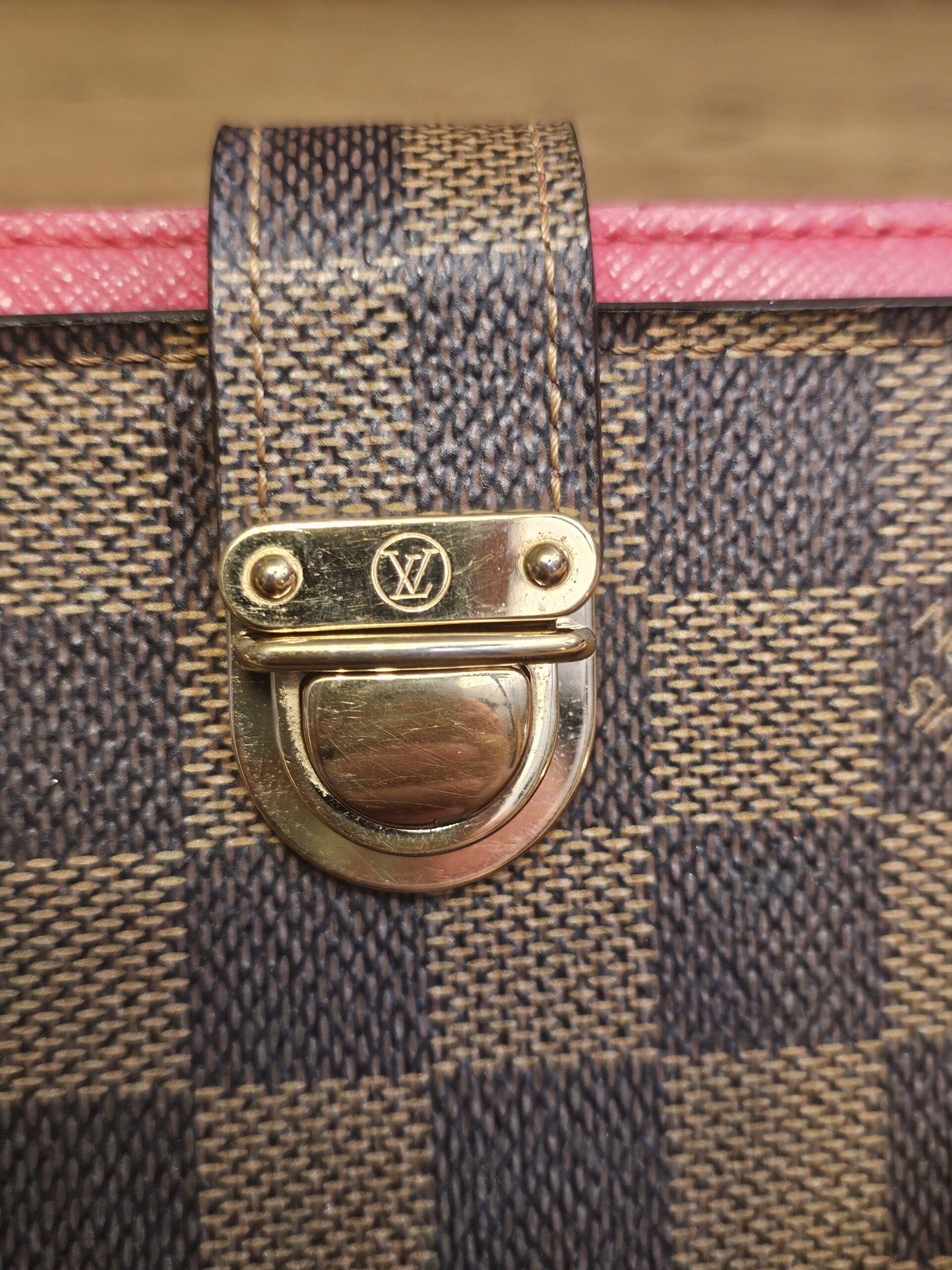 Gold-tone Koala push-lock closure with the LV logo