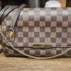 Louis Vuitton Damier Ebene Favorite MM - the bag with its brown leather strap and gold-tone chain