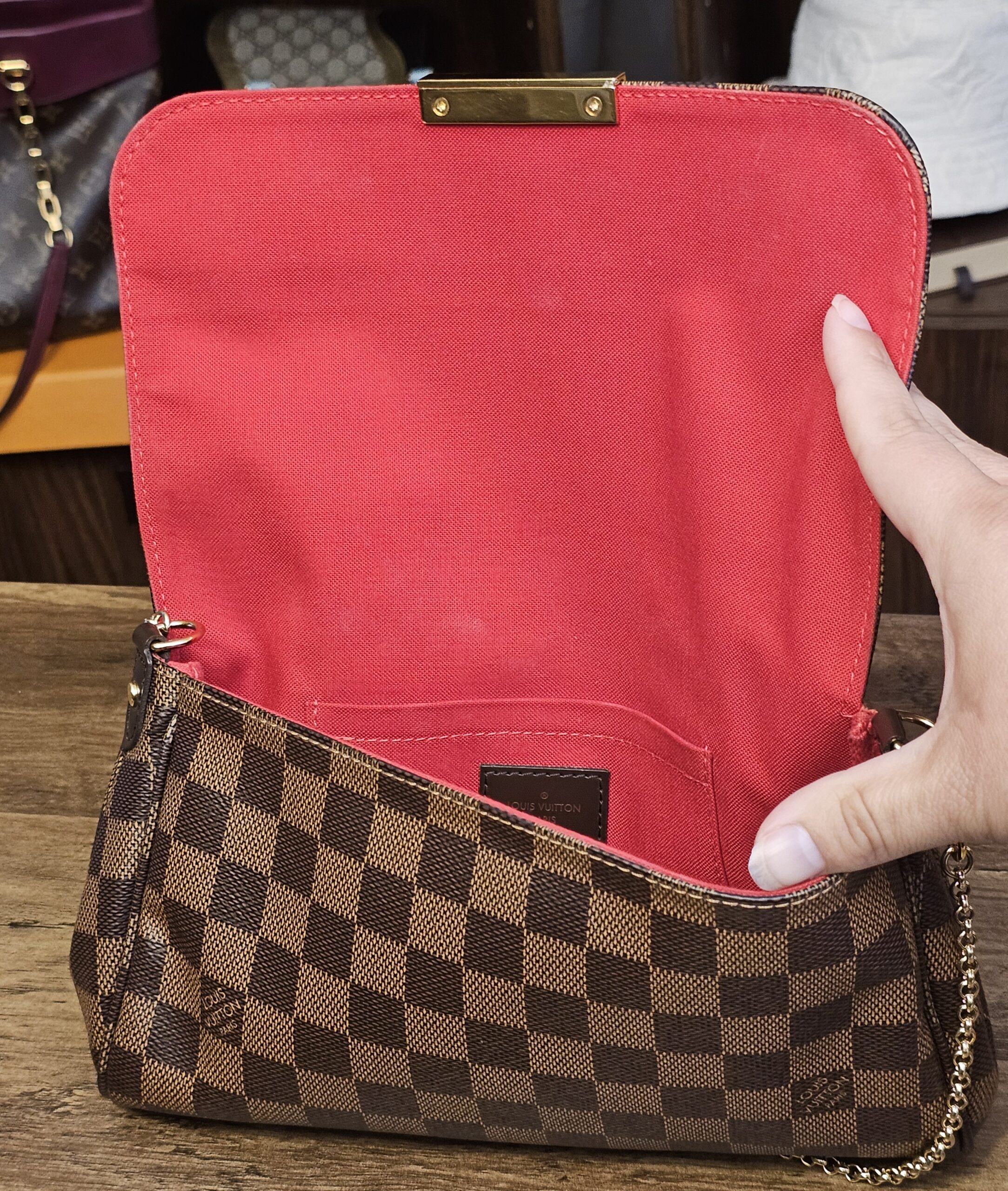 Flap lifted to show the red textile interior