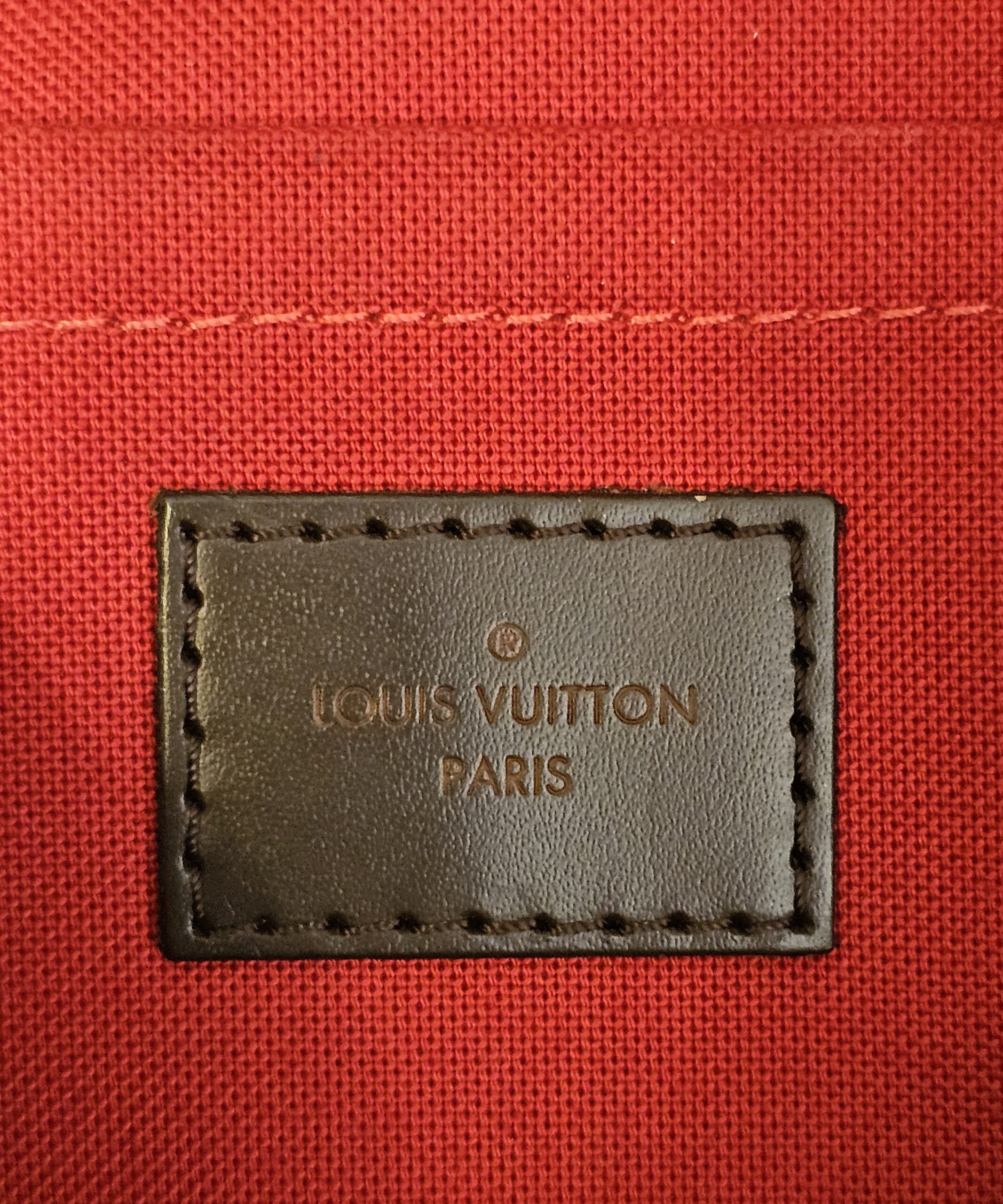 LOUIS VUITTON PARIS patch on the red interior