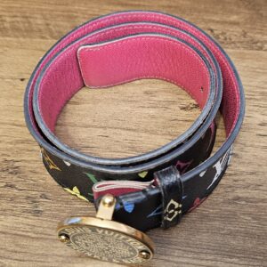Belt coiled to show the bright pink leather interior