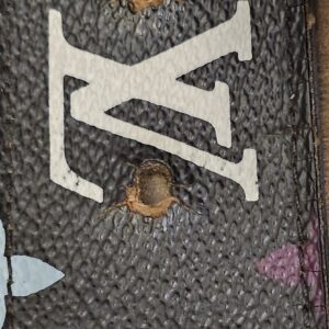 Black Multicolor canvas showing cracks around the belt holes