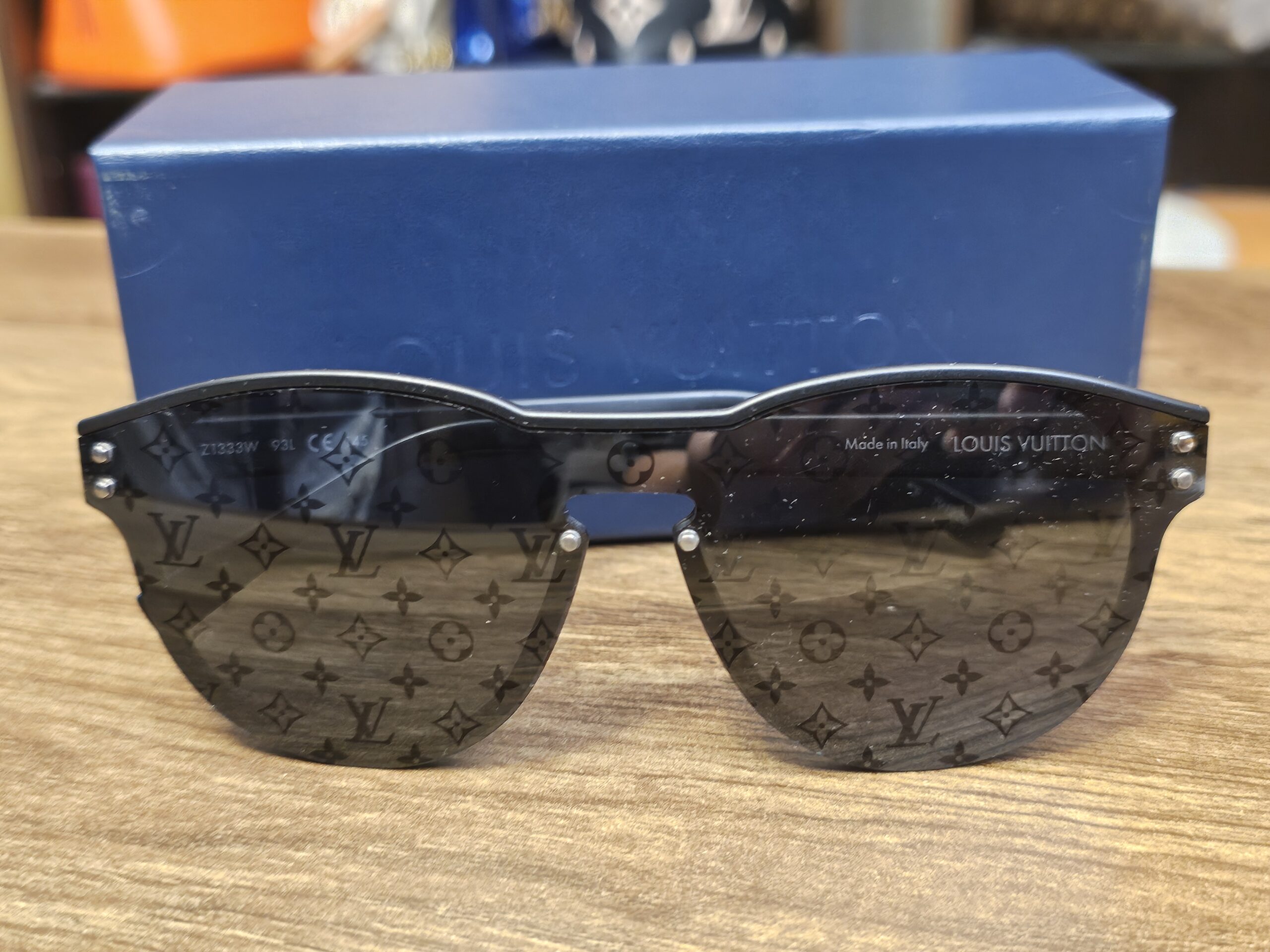 Louis Vuitton Z1333W Waimea Monogram Sunglasses Black - front view on the blue Louis Vuitton box