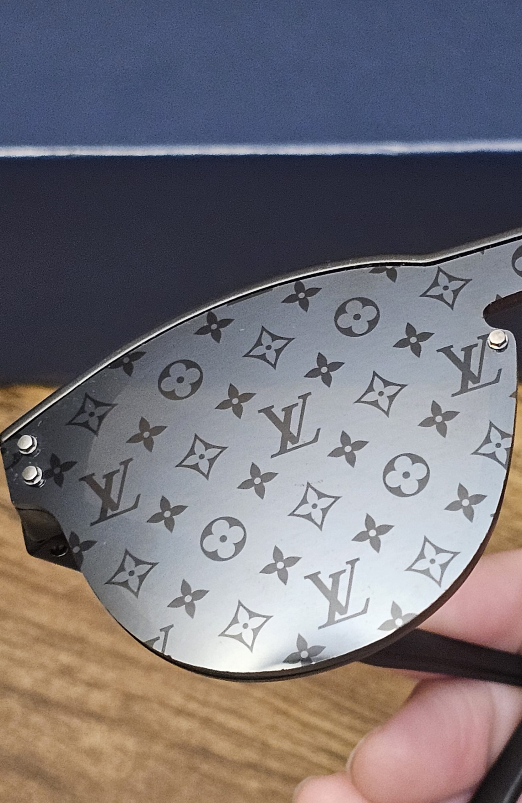 Close-up of the Monogram pattern on the dark lens