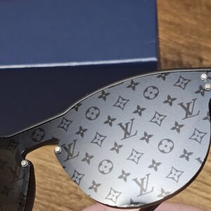 Monogram-patterned lens seen at an angle