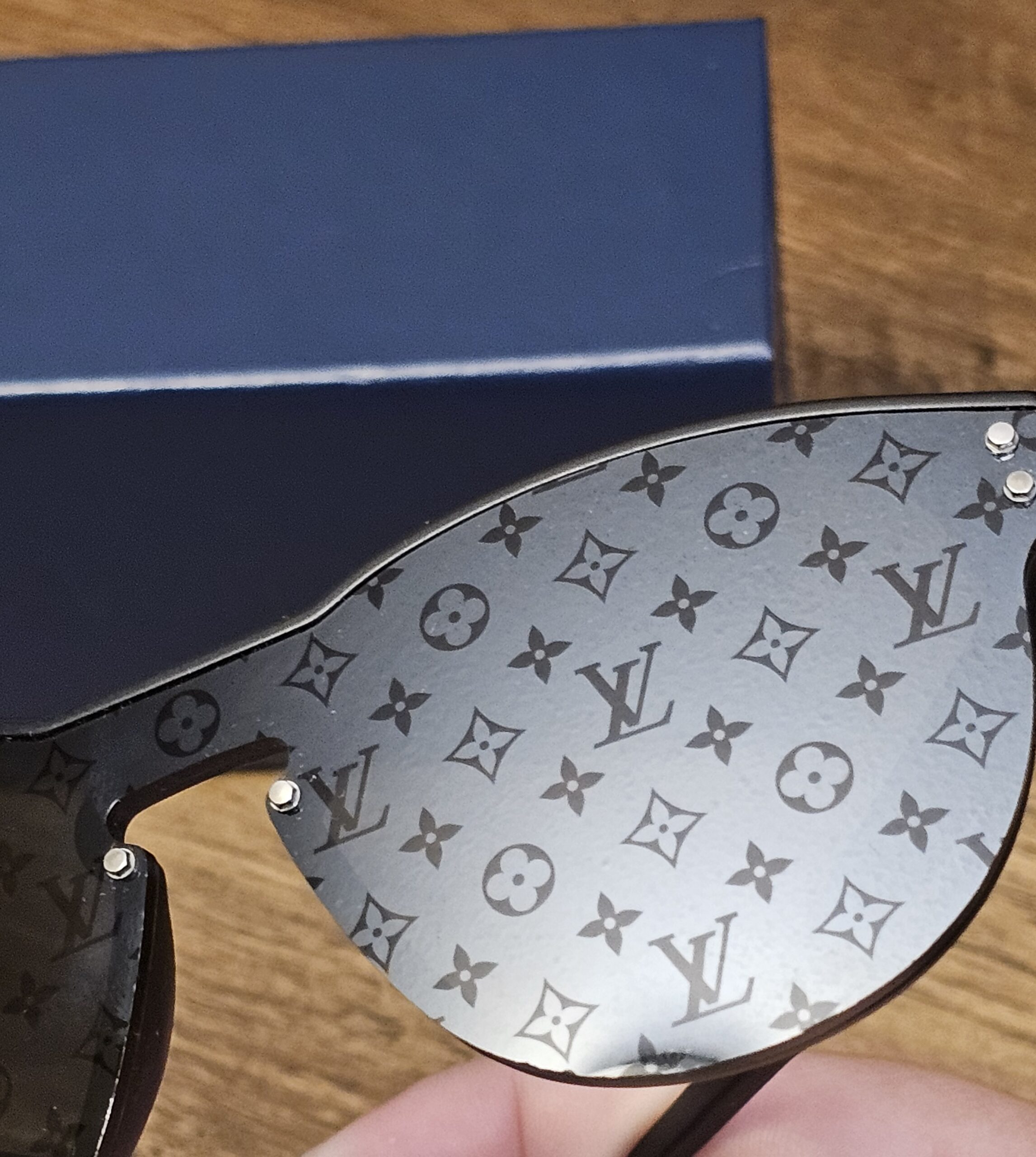 Monogram-patterned lens seen at an angle