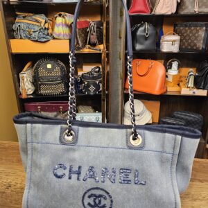 Chanel Sequin Denim Small Deauville Tote Blue shown front on with the navy sequin CHANEL logo, CC and 31 Rue Cambon