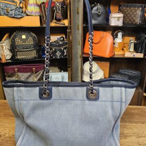 Back of the washed blue denim Deauville tote with the navy leather and chain straps