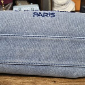 Base of the denim tote embroidered with PARIS in navy thread