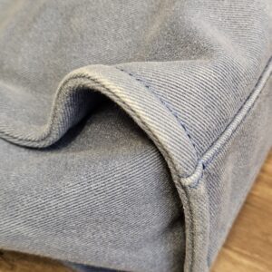 Opposite bottom corner of the blue denim tote with normal softening and creasing
