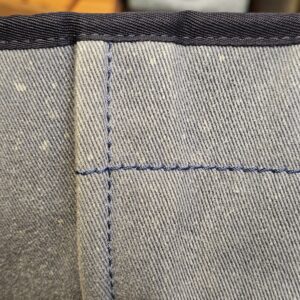 Flat exterior pocket panel on the washed denim Deauville tote