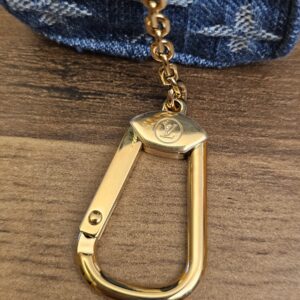 Close up of the oversized gold-tone clasp engraved with the LV initials