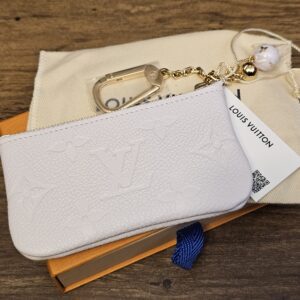 Sweet Lavender Empreinte key pouch showing the embossed Monogram and gold-tone chain