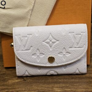 Louis Vuitton Monogram Empreinte Rosalie Coin Purse Sweet Lavender shown front on with the embossed Monogram and snap closure