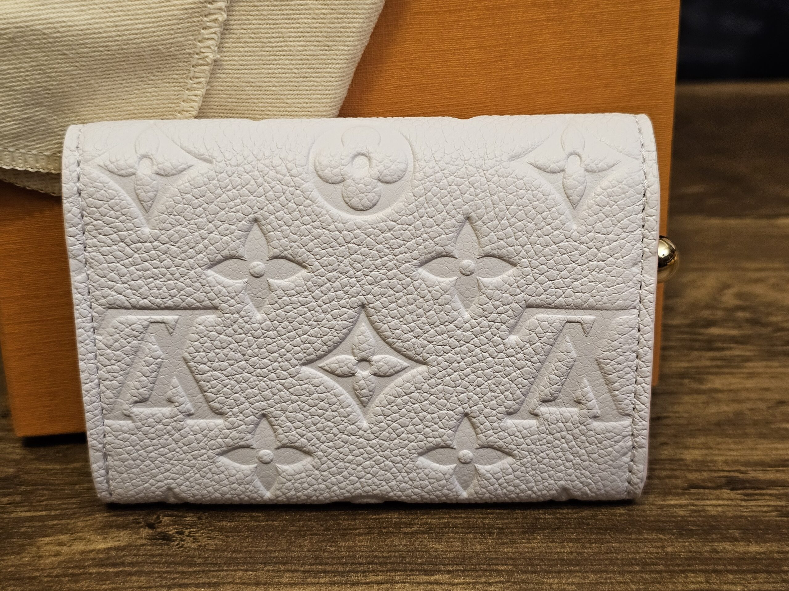 Back of the Sweet Lavender Empreinte Rosalie coin purse showing the embossed Monogram