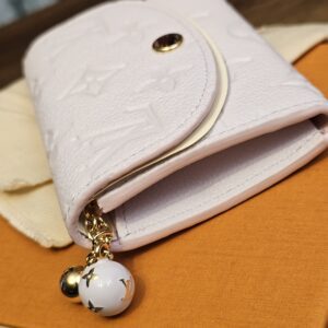 Side of the Rosalie coin purse with the enamel Monogram flower charm on the zip pull