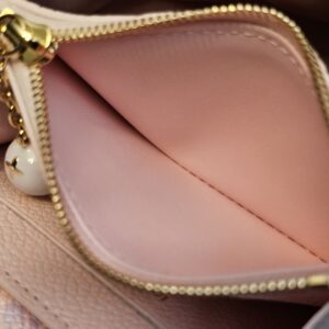 Zipped coin compartment of the Rosalie coin purse held open