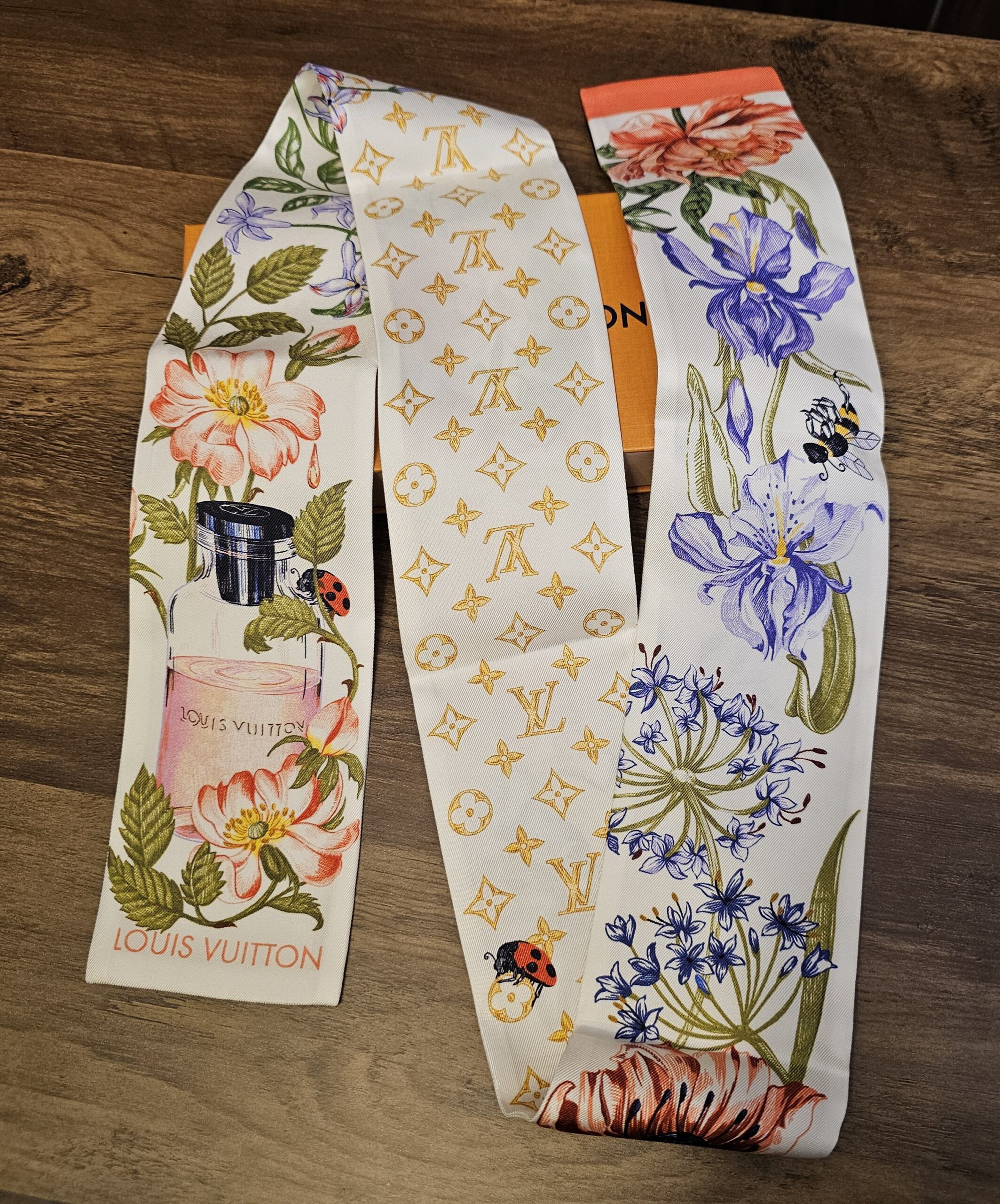 Louis Vuitton Silk Monogram Fontaines Parfumees Bandeau Pink folded to show the florals and the gold Monogram