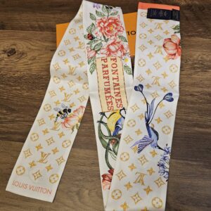 FONTAINES PARFUMEES lettering panel on the silk bandeau beside roses and irises