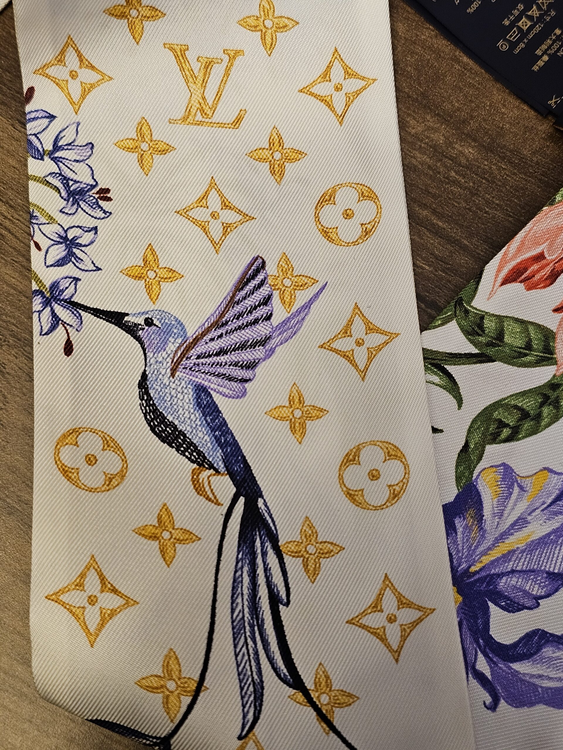 Hummingbird and iris printed over the gold Monogram on the silk bandeau