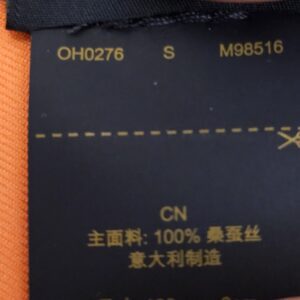 Reverse of the care label showing style code M98516 and 100 percent silk
