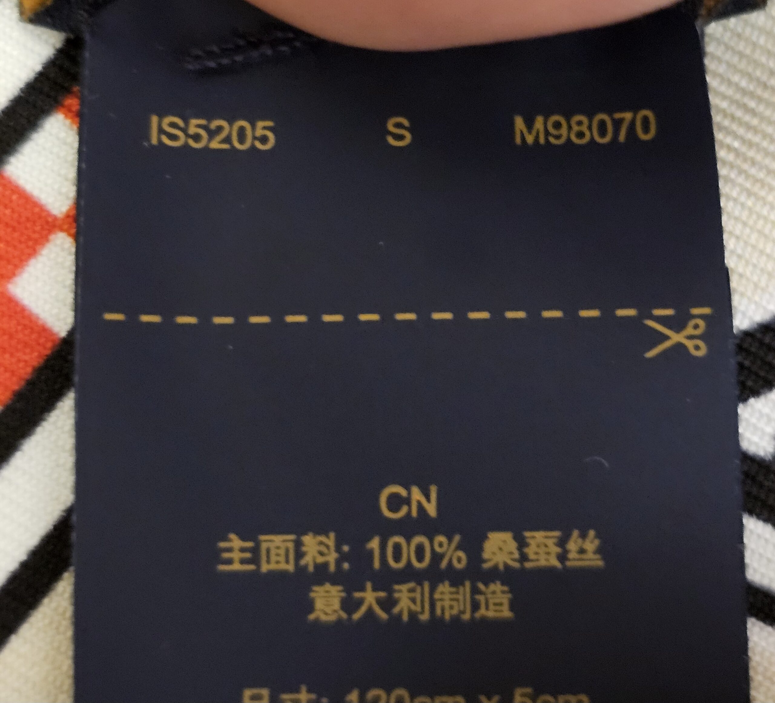 Reverse of the care label showing style code M98070 and production code IS5205