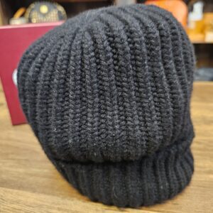 Close view of the black ribbed knit and the folded cuff
