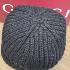 Crown of the beanie seen from above showing the knit panels